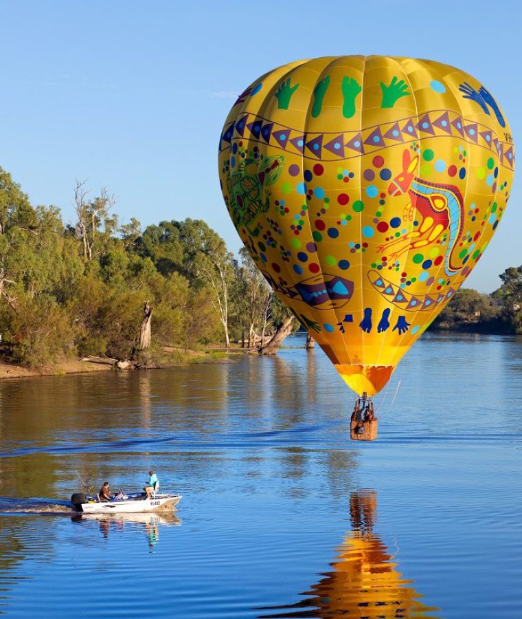 Colourful balloon drifts slowly over the River Murray near Wentworth, NSW, Australia